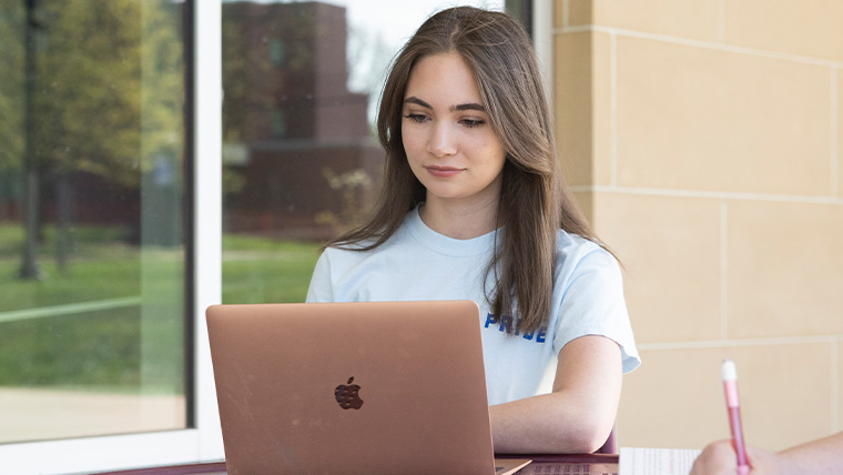 Student works on a laptop