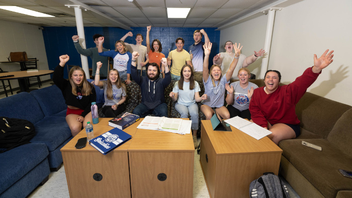 students cheering in Grizzly House lounge