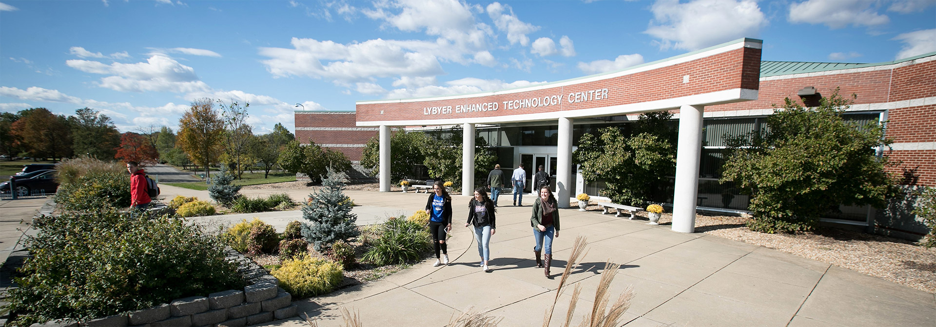 Three students outside the Lybyer building
