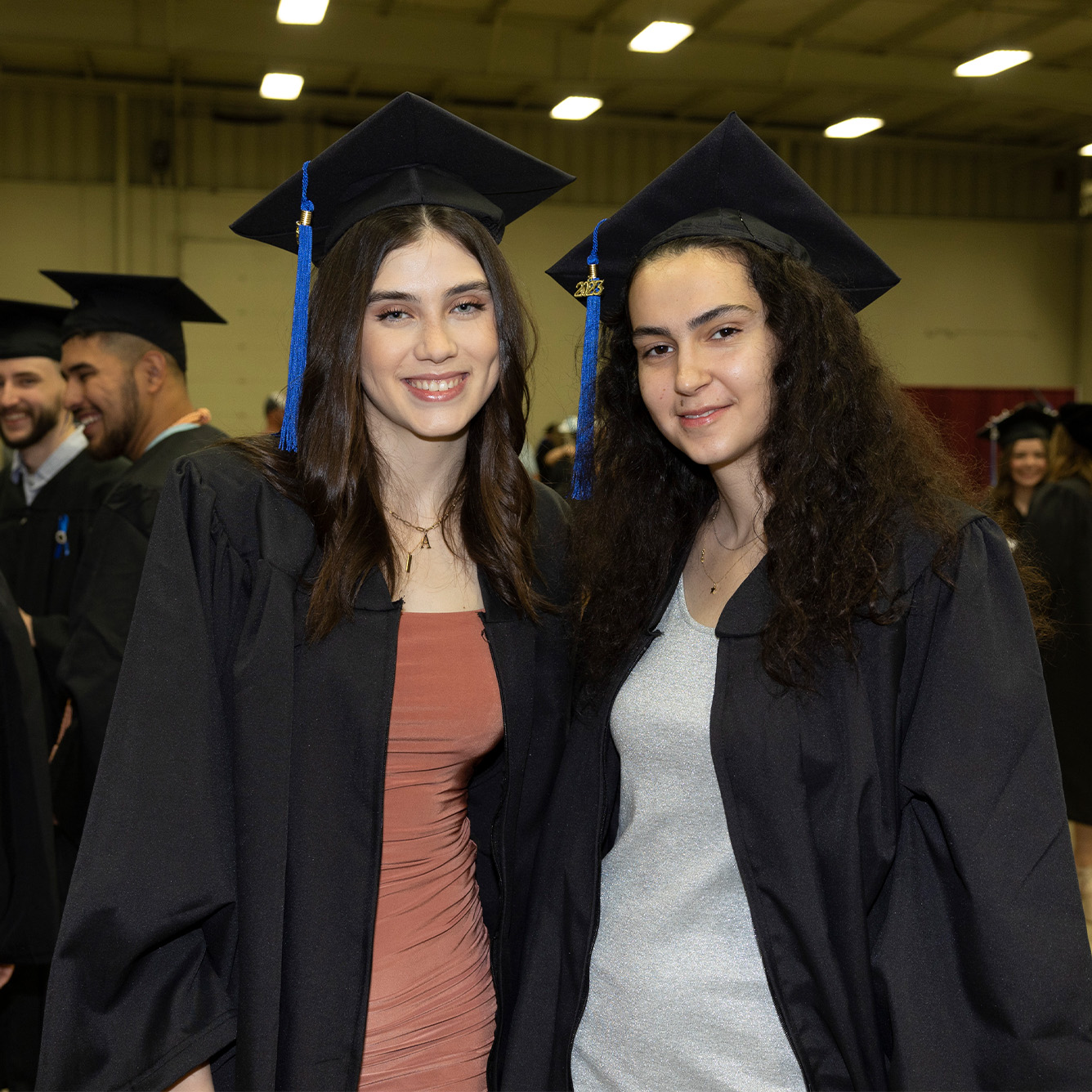 Two graduates at commencement